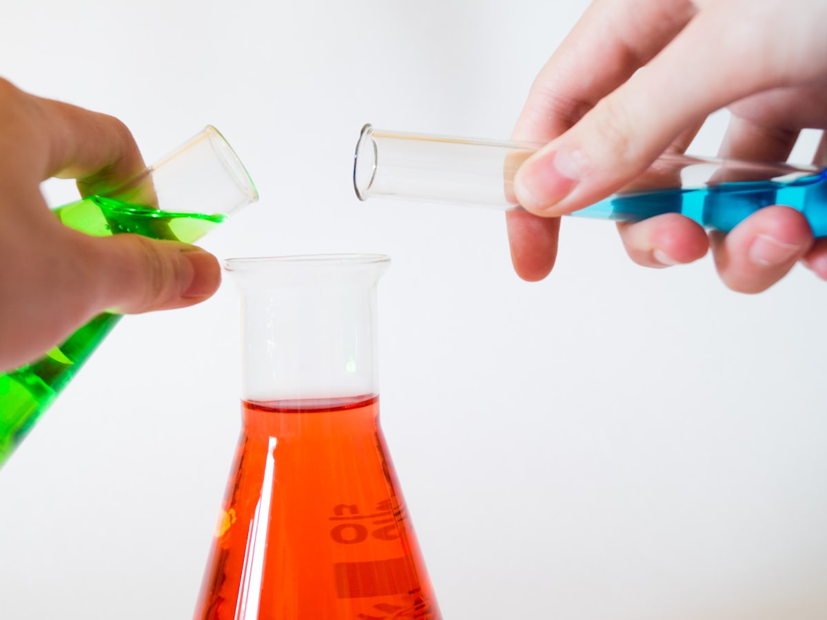 Laboratory glassware being handled at a bench
